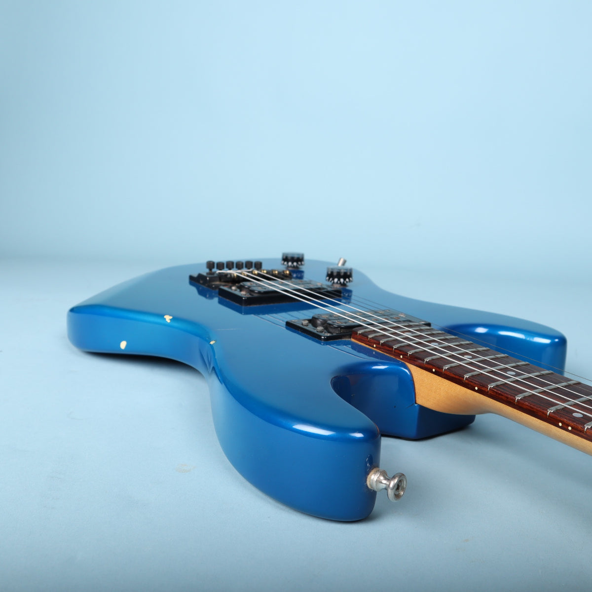 Side profile along the lower cutaway and fretboard edge