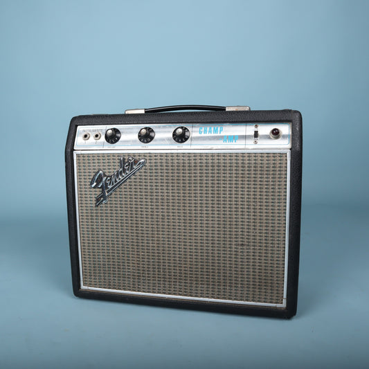 Top front angled view highlighting control knobs, input jacks, and carrying handle.