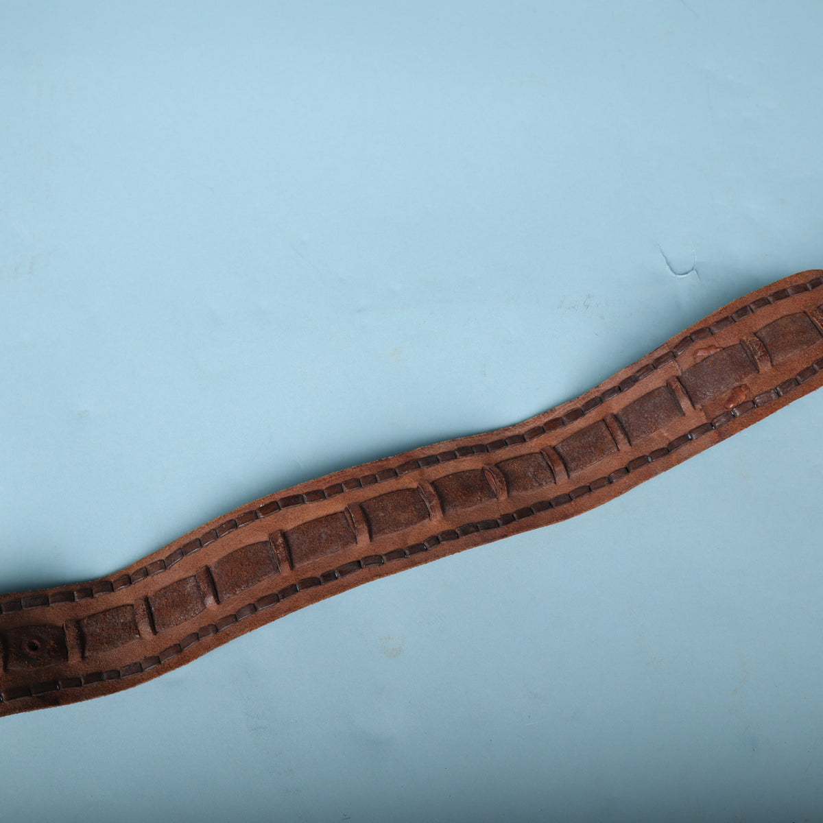 Midsection of the brown leather guitar strap showing whipstitch borders