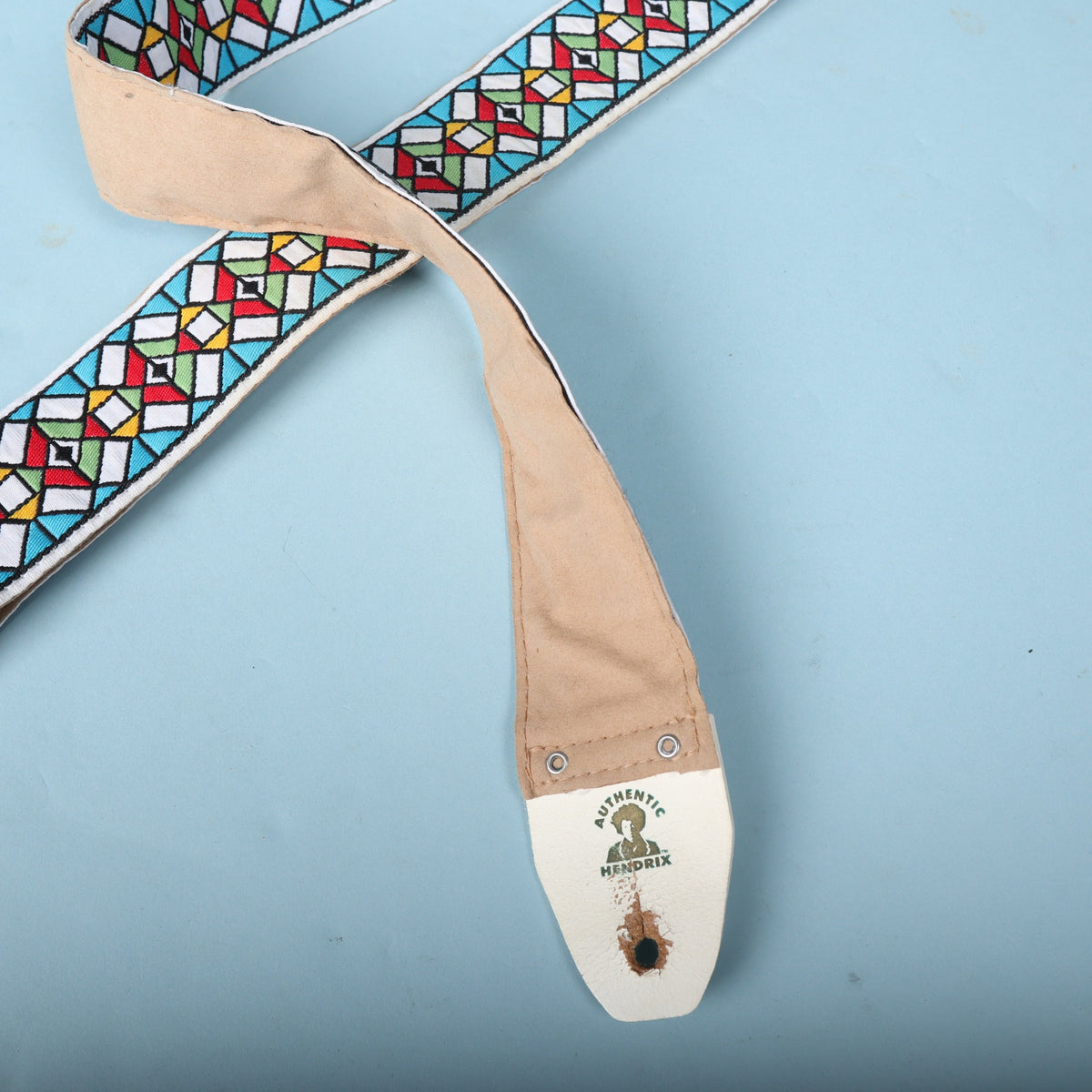Overview of the strap showing the woven design alongside the tan backing leading down to the logo tab