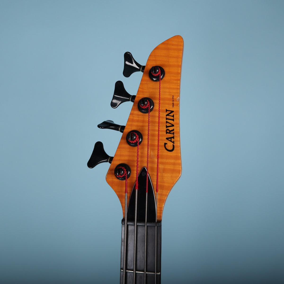 Headstock face displaying the Carvin logo, truss rod cover, and Made in USA marking.