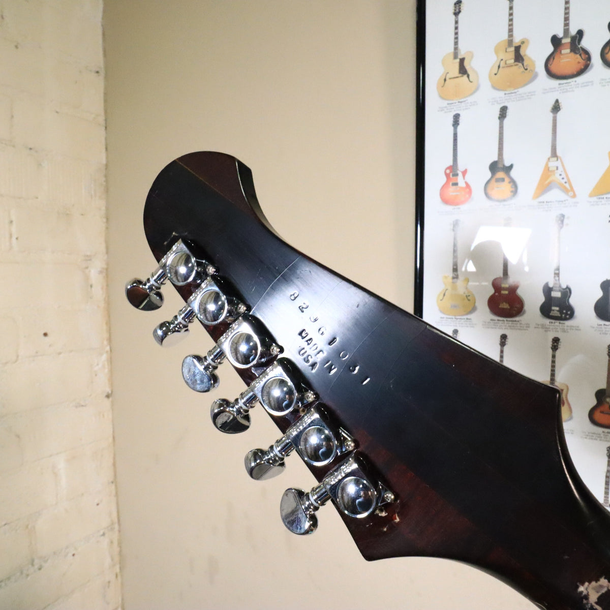 Angled view of the back of the headstock showing the serial number and chrome Grover tuning machines.