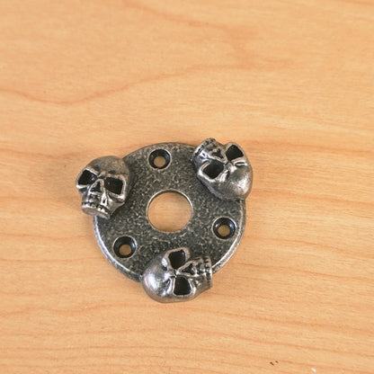Top-down perspective view of the Gunther three-skull guitar accent plate.