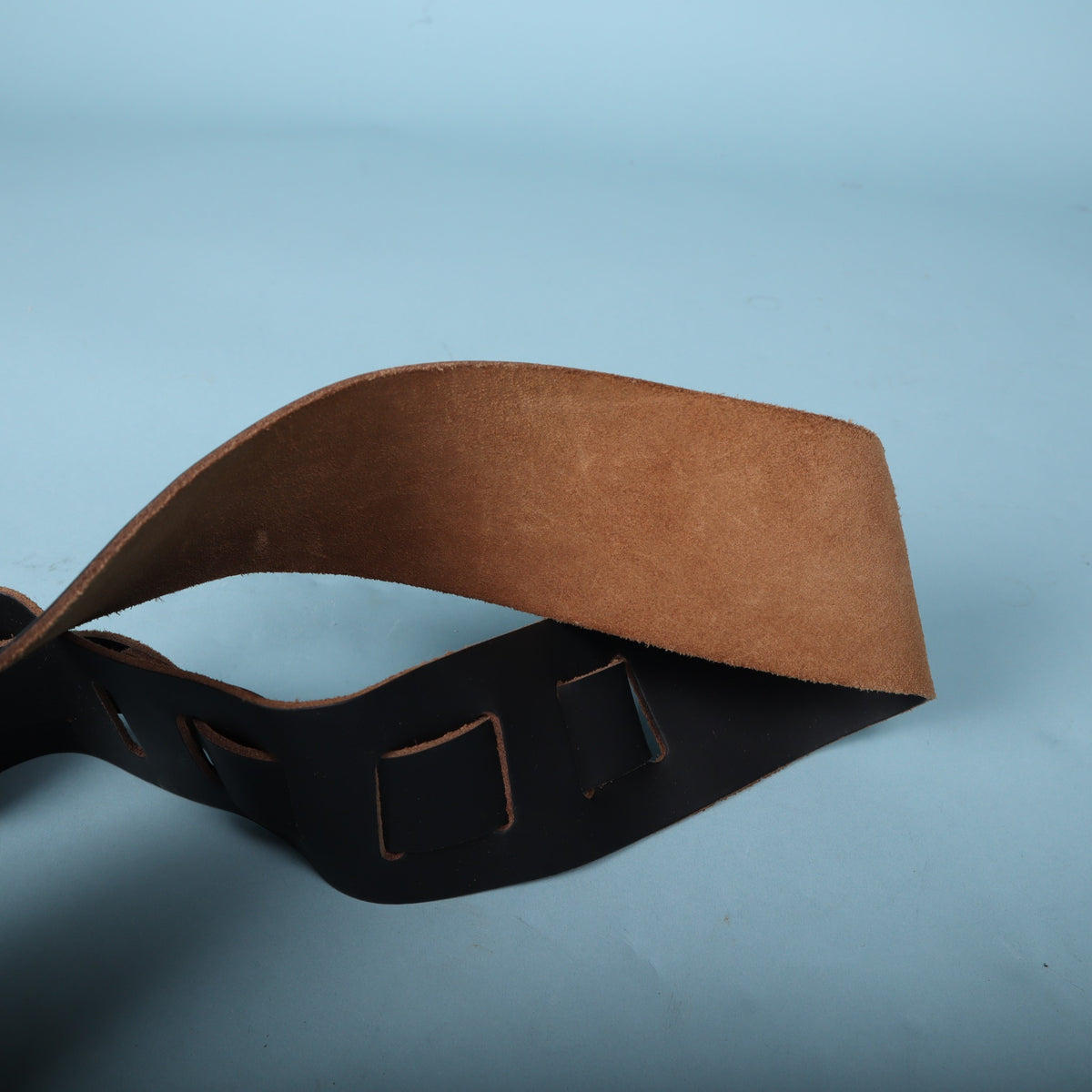 Close-up of the tan suede backing and feed-through adjustment slots on Jackson leather strap