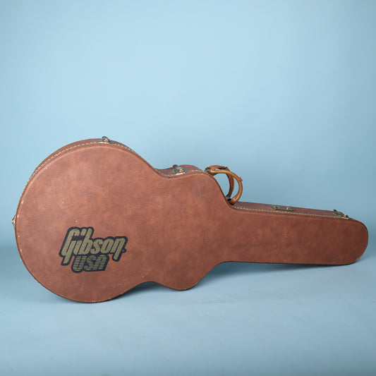 Top-down view of the closed brown Gibson case showing the complete Gibson USA logo