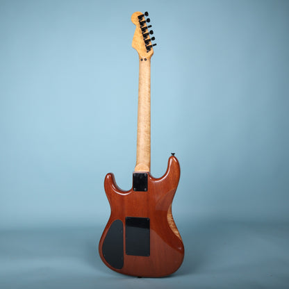 Full rear view of Warmoth electric guitar against blue backdrop.