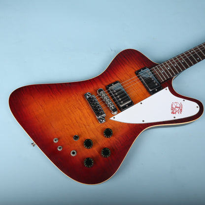 Front face view of the carved flame maple body showing the bridge, pickups, pickguard, and control knobs.