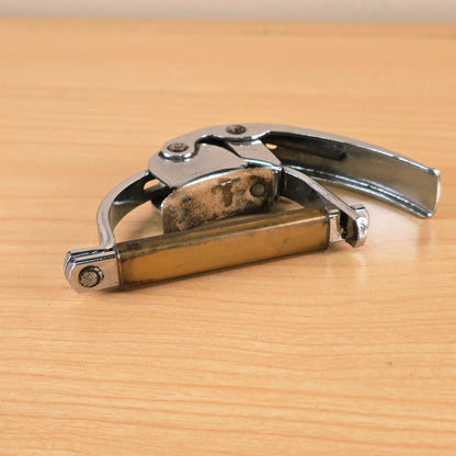 Low profile perspective of the Hamilton KB19A capo with the string bar facing forward.