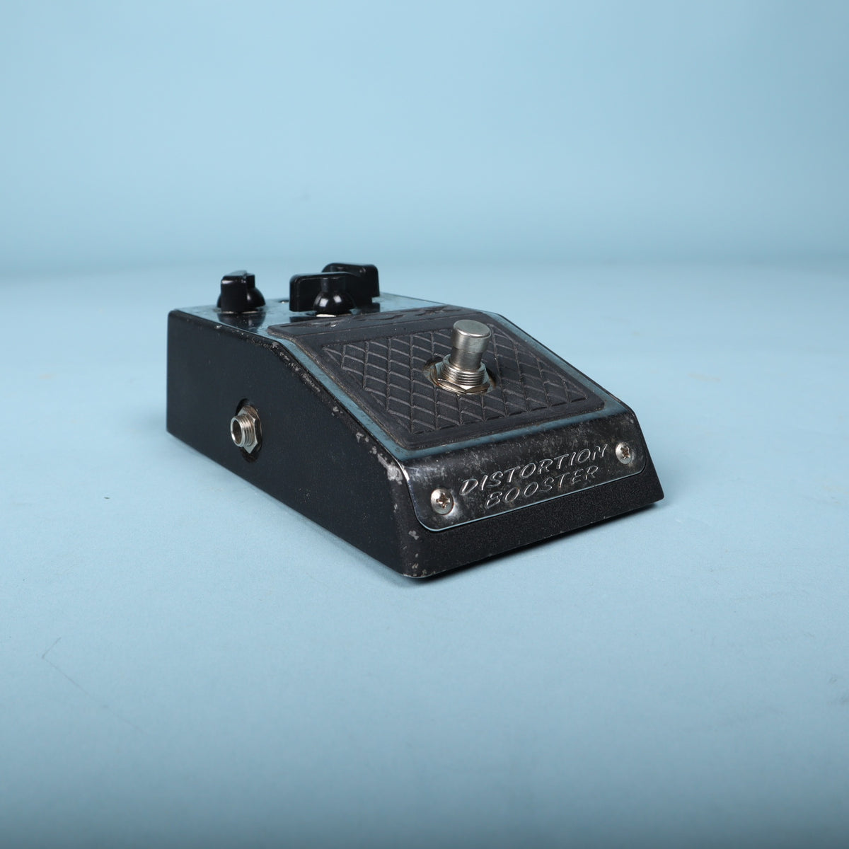 Front angled view focusing on the engraved Distortion Booster front plate