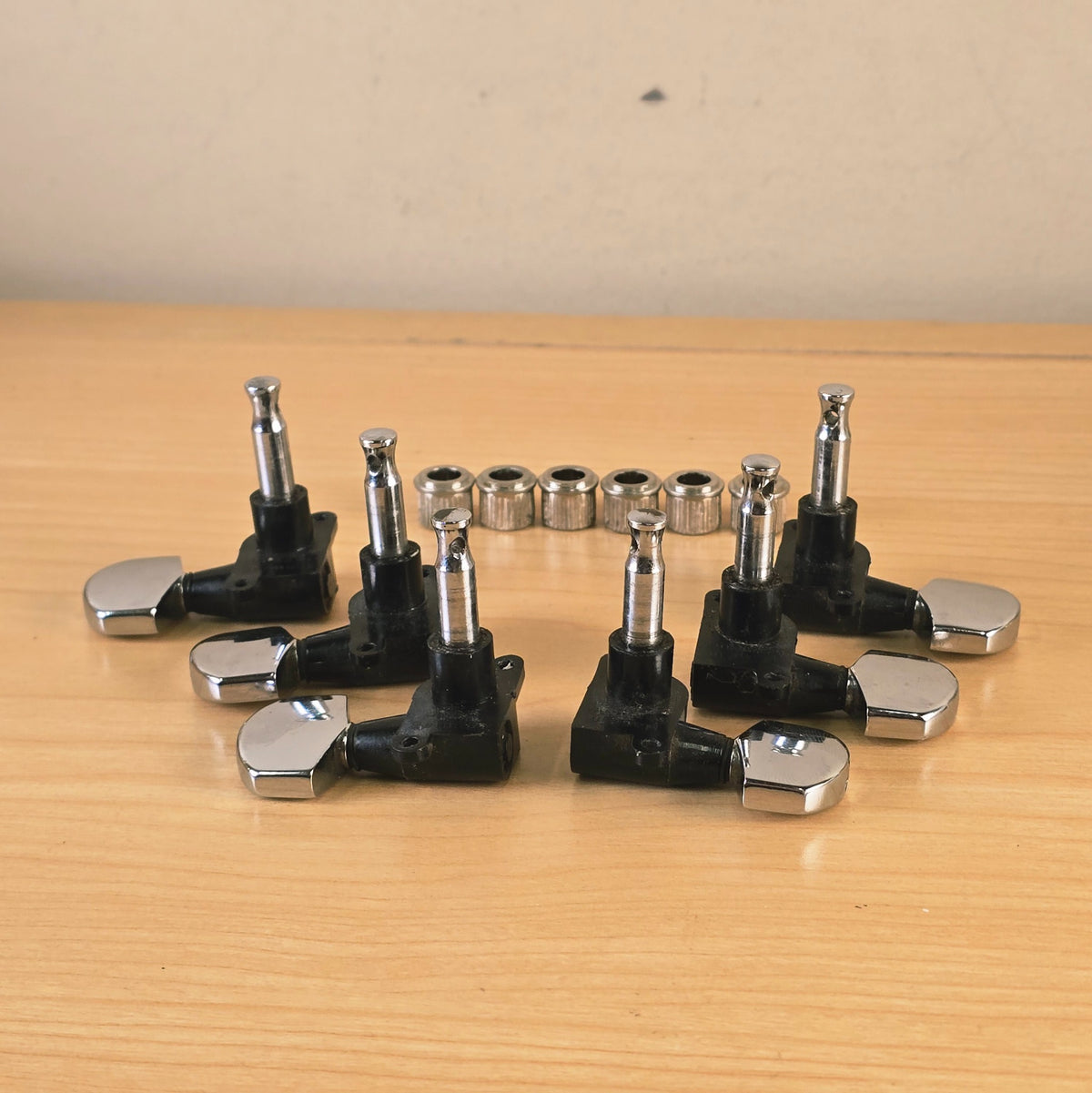 Overhead view of six Schaller tuning machines and bushings facing upward