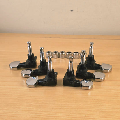 Overhead view of six Schaller tuning machines and bushings facing upward