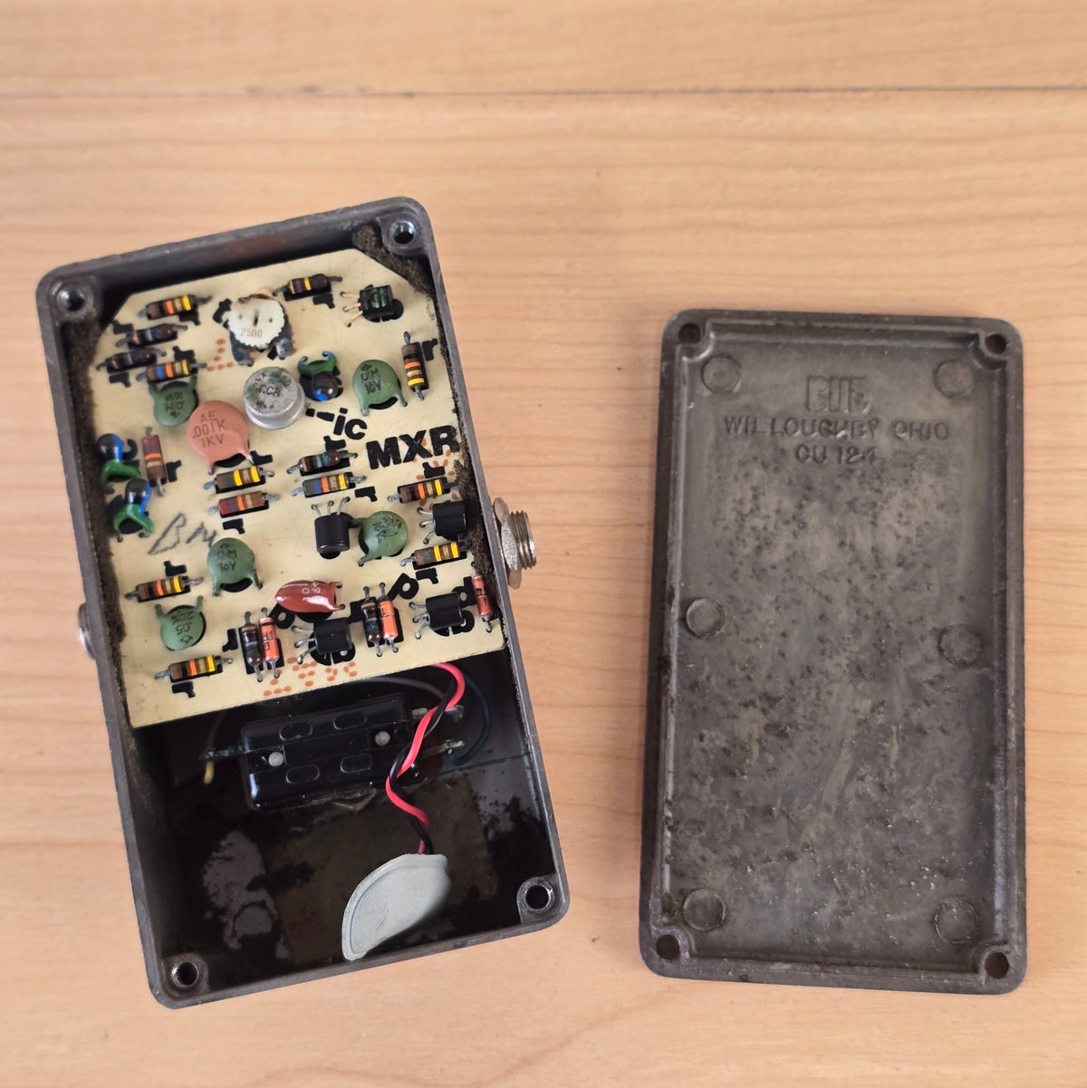 Interior view showing the circuit board with metal-can IC and the interior of the Bud box backplate.
