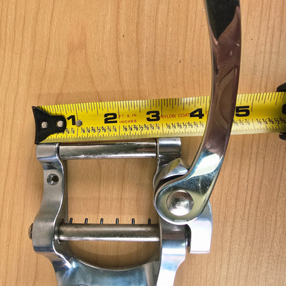 Measurement of the front roller assembly depth with a tape measure showing about 3 inches.