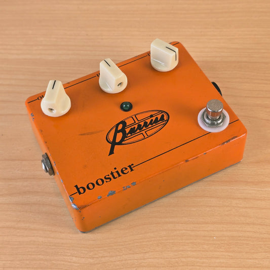 Top-down angled view of the Barriss Boostier pedal showing all three white control knobs.