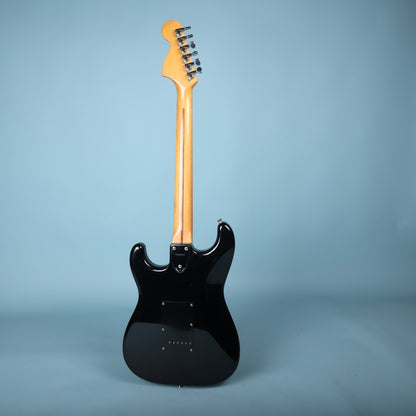 Full rear profile view of Squier Stratocaster electric guitar on blue background.