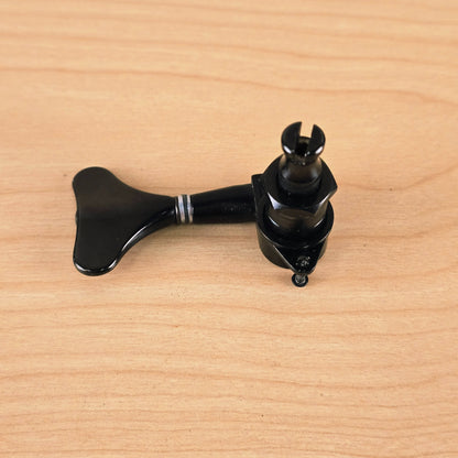 Top-down view of the Gotoh Modulus bass tuning peg displaying the threaded post and mounting screw tab