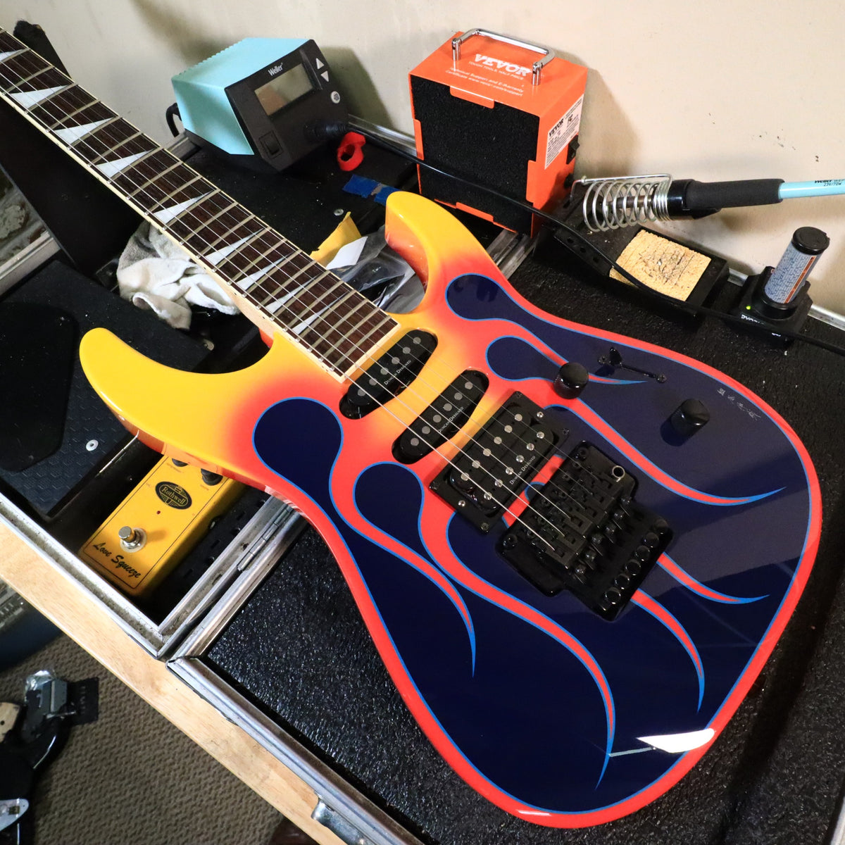Front body resting on workbench showing pickups and tremolo assembly