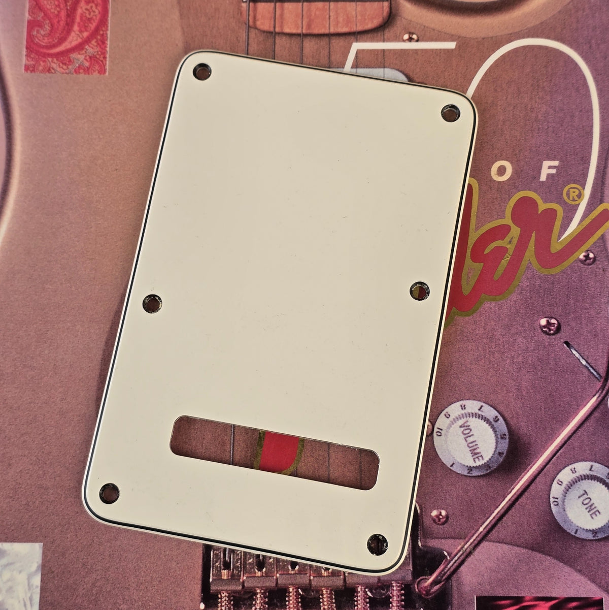 Fender Stratocaster off white tremolo cover plate angled view