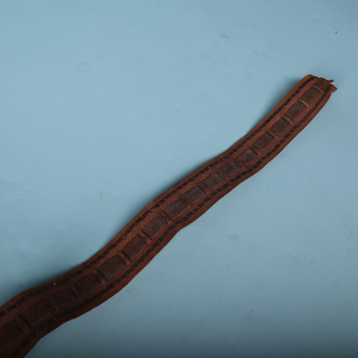 Tail end of vintage laced leather guitar strap