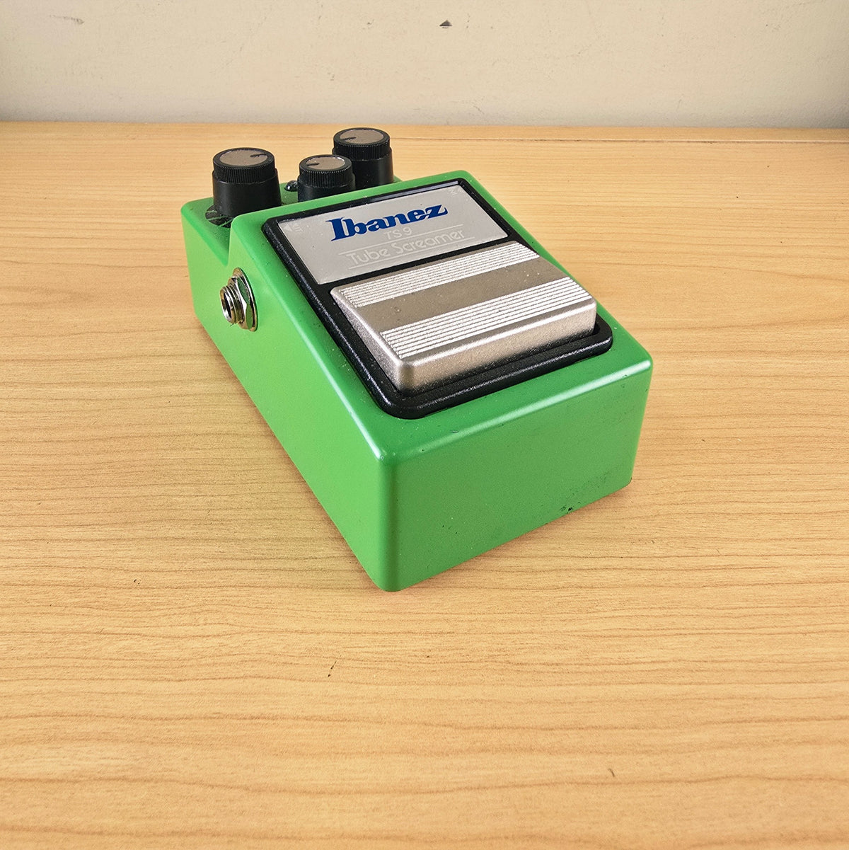 Low-angle view of the front faceplate and footswitch of the Ibanez TS9 Tube Screamer.