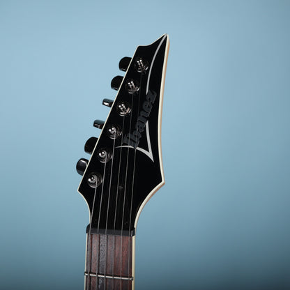 Front view of black Ibanez headstock with white binding