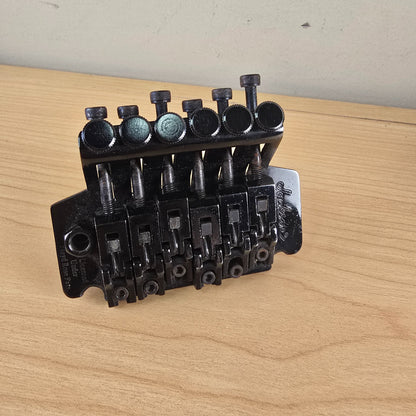 Perspective top view of black Jackson tremolo assembly