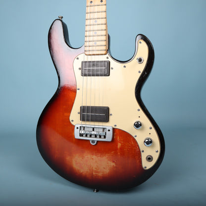 Front view of the body of a sunburst Peavey T-15 electric guitar.