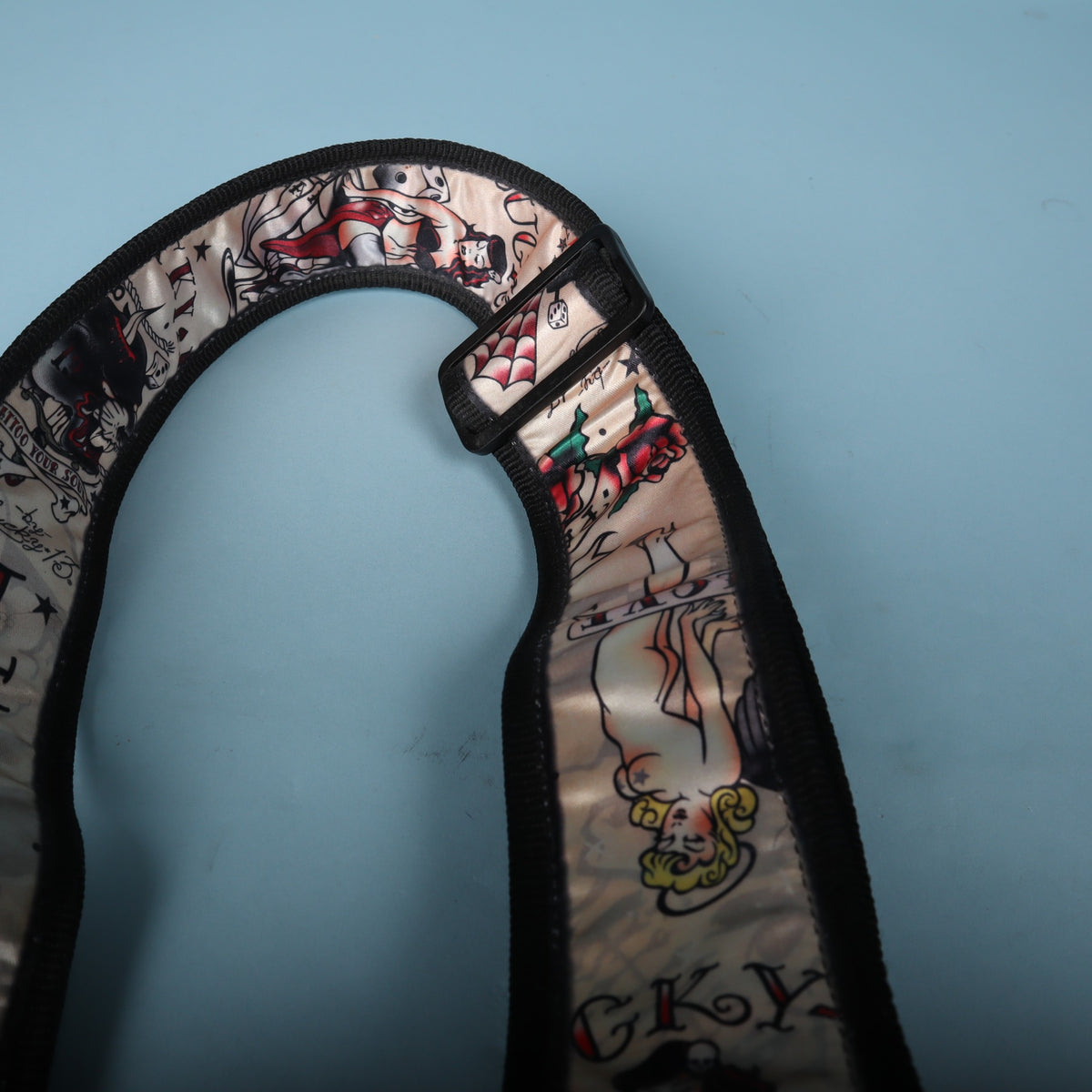 Close-up of the pin-up girl graphic and webbing on the upper strap section