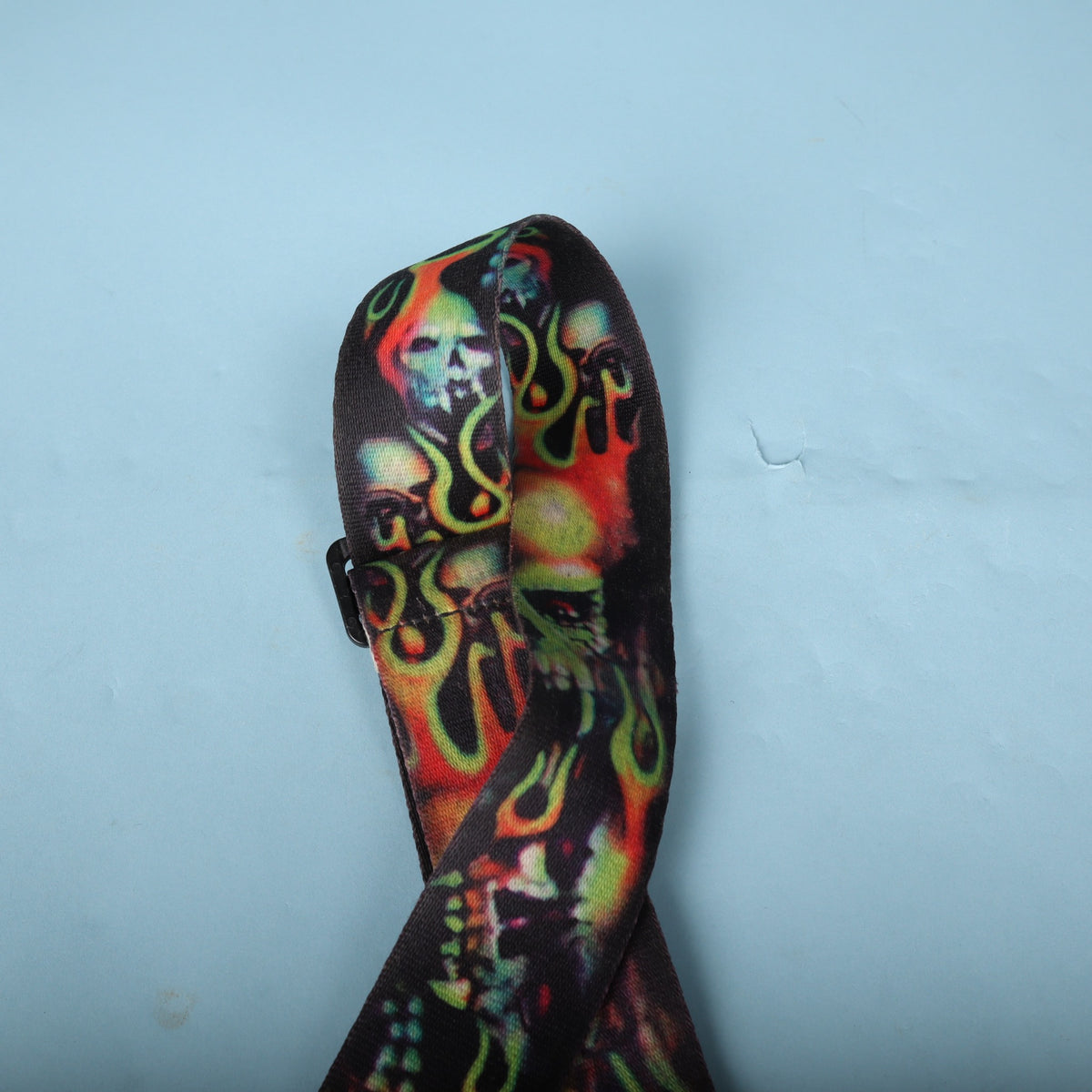 Top loop of the strap showing the vivid skull graphic pattern.