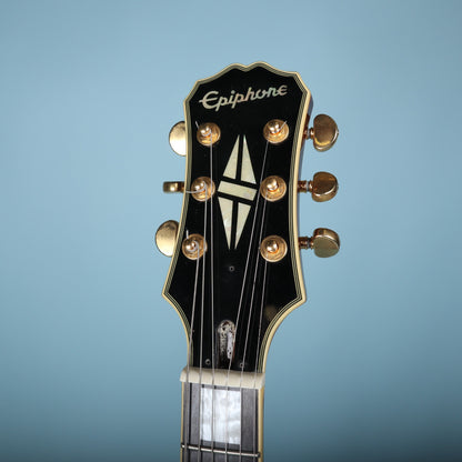 Front headstock view of Epiphone Les Paul Custom showing logo and split-diamond inlay