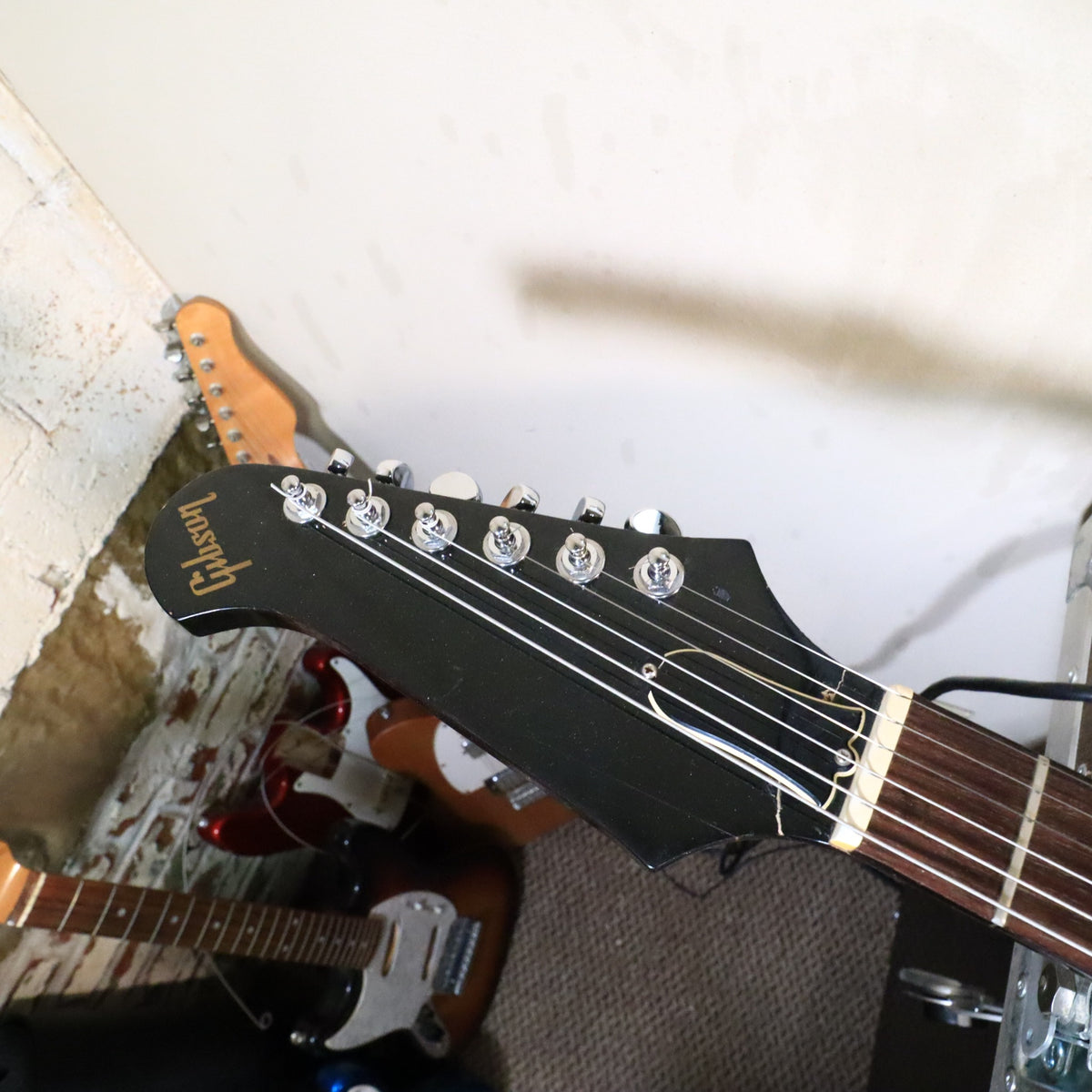 Front view of the headstock resting on a bench with workshop tools in the background.