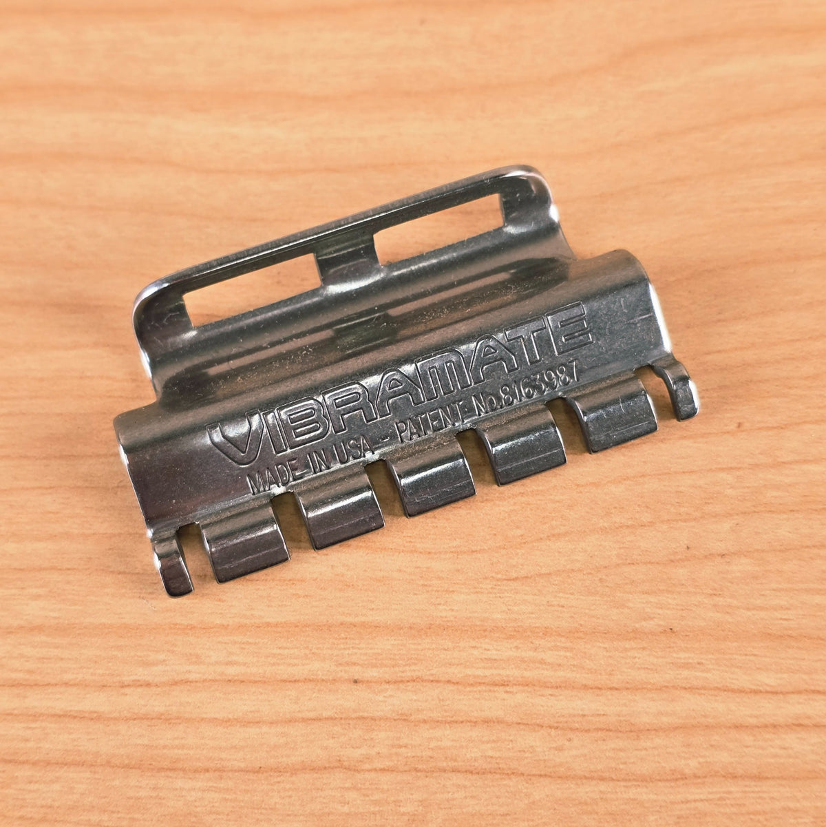 Front-facing angled view of the Vibramate Spoiler displaying the six individual string retention channels.