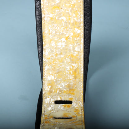 Detailed section of the padded body showing the pearloid inlay and ladder adjustment slots.
