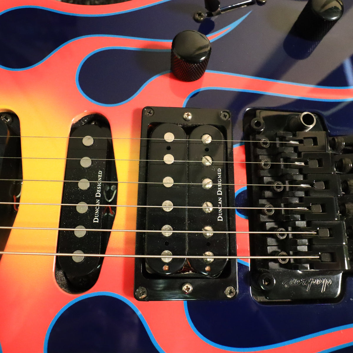 Close-up detail of Duncan Designed pickups and Jackson licensed Floyd Rose bridge