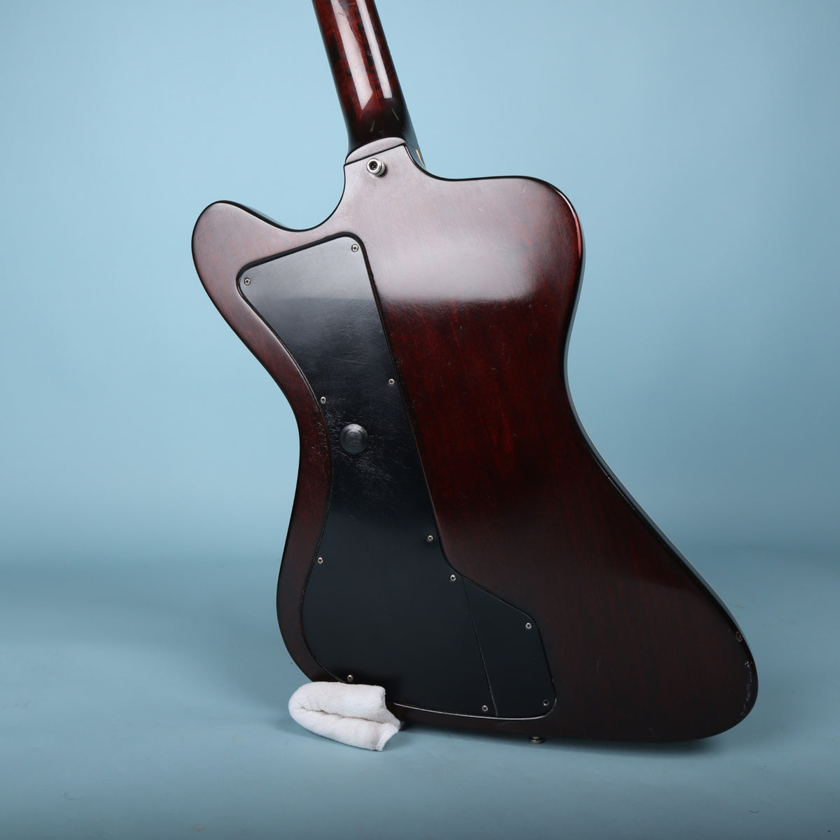 Rear three-quarter view of the guitar body highlighting the dark cherry finish and active electronics access plate.