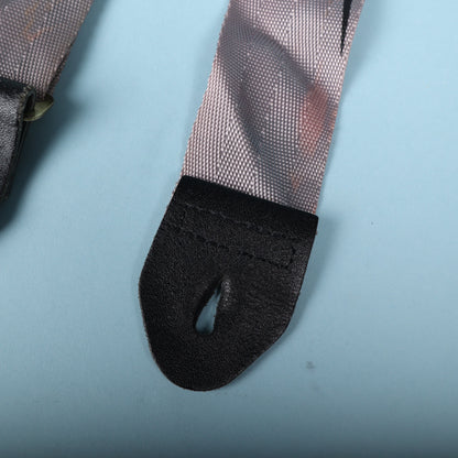 Close-up of the black leather strap end showing stitching and button hole slit.