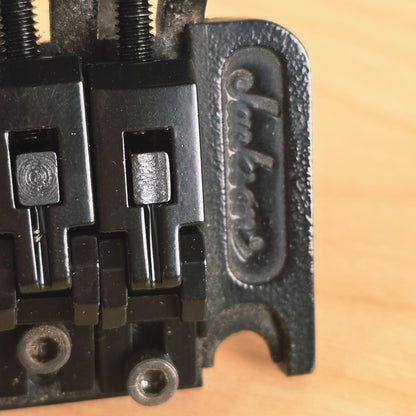 Close-up detail of the cast Jackson logo on the bridge baseplate.