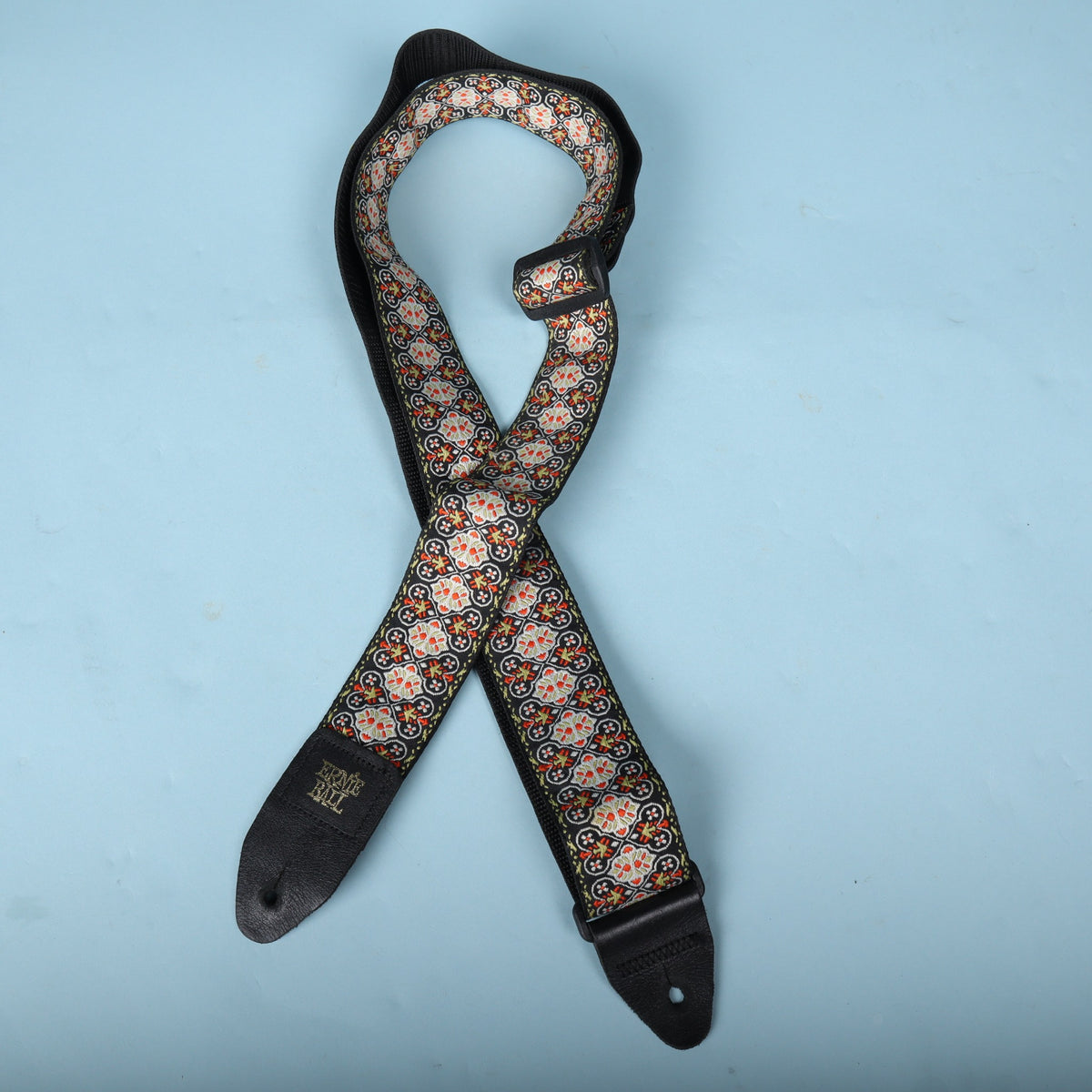 Full layout of the Ernie Ball jacquard strap crossed over on a solid background