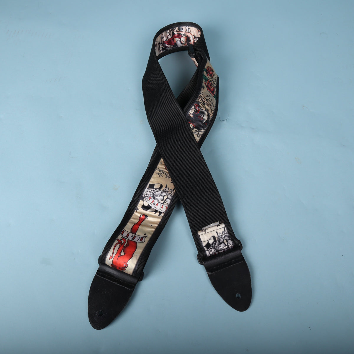 Back view of the crossed strap showing the heavy black woven nylon backing and leather ends