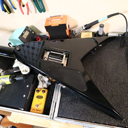 Back view of the body showing the open tremolo spring cavity and electronic control cover