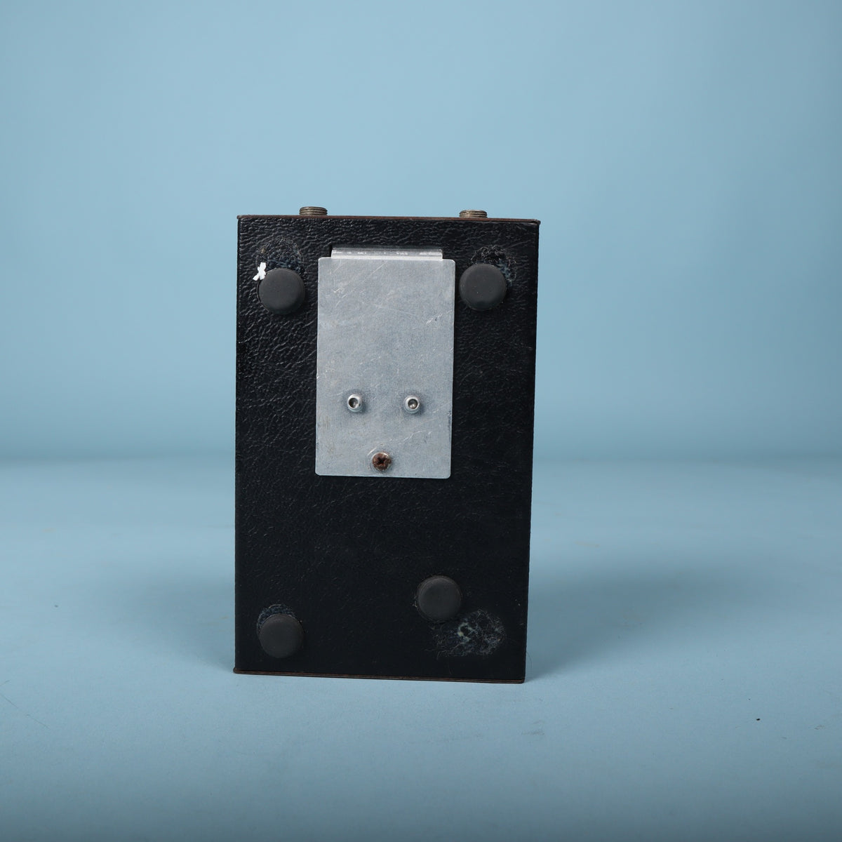 Underside showing the battery door and rubber feet.
