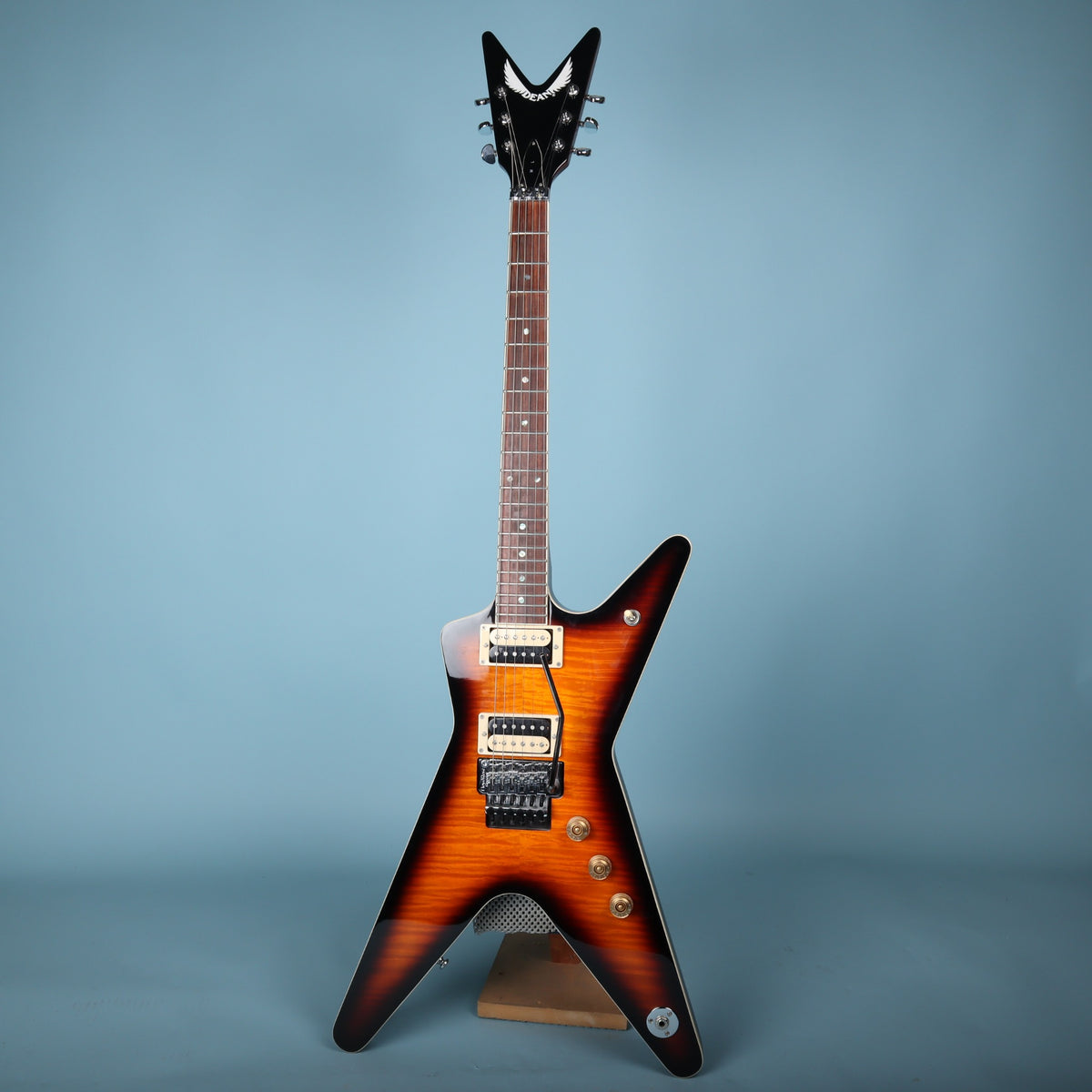 Full front view of Dean ML electric guitar resting on guitar stand