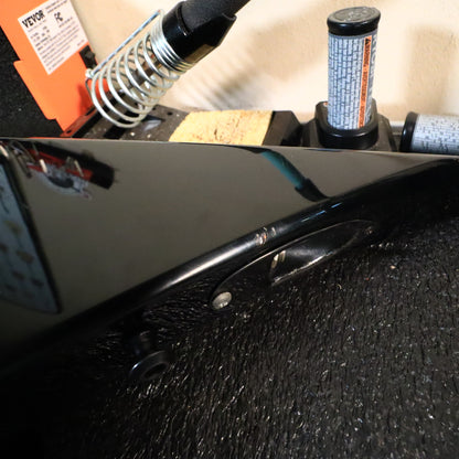 Close-up of the recessed output jack and strap button on the inner bevel