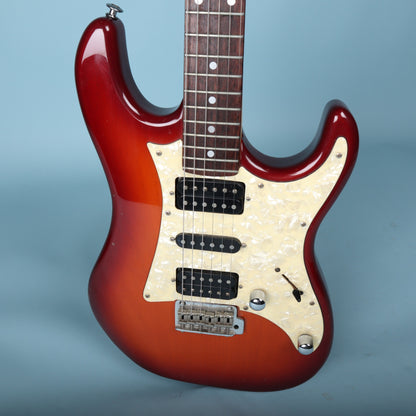 Front body detail showing pearloid pickguard, humbuckers, single coil pickup, and knobs.