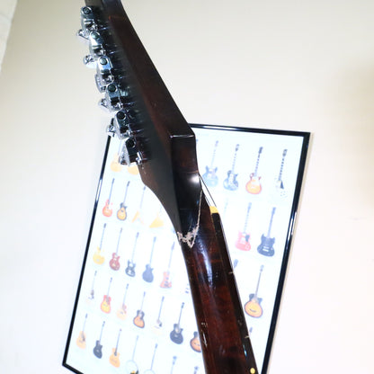 Angled side view showing the repair line along the neck and headstock joint.