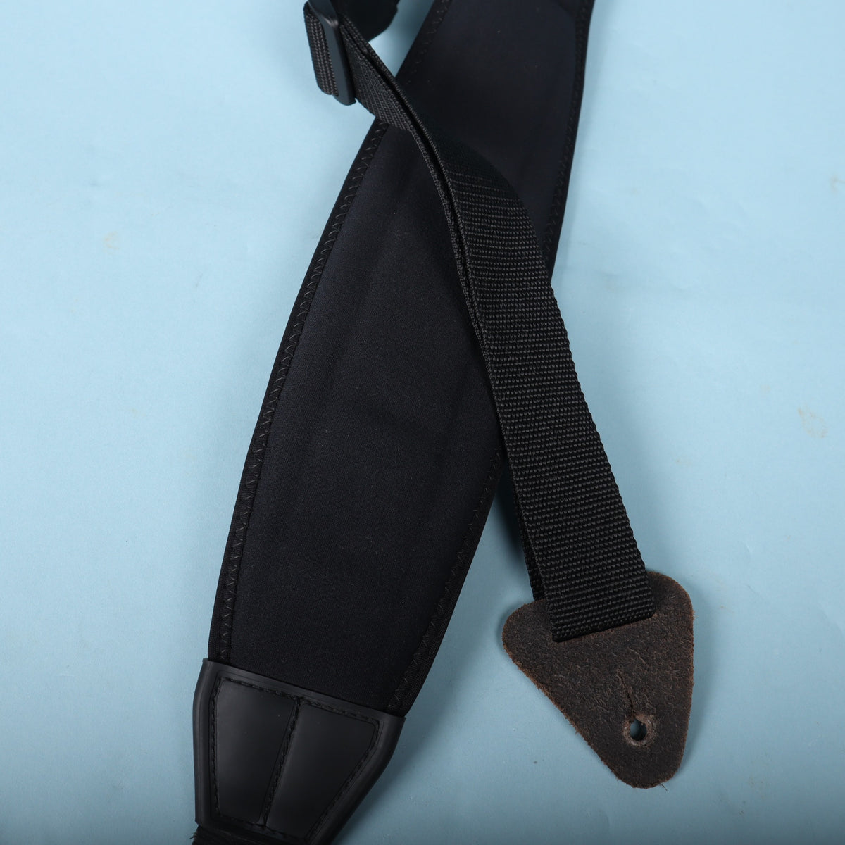 View of the crossed nylon webbing and leather mounting tab.