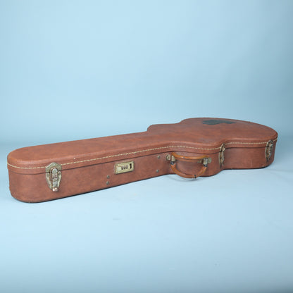 Closed Gibson hardshell guitar case front-side view showing latches, handle, and combination lock
