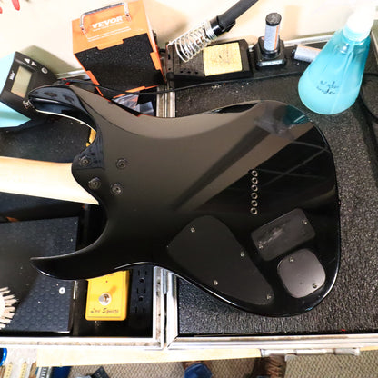 Back of gloss black body lying on workbench