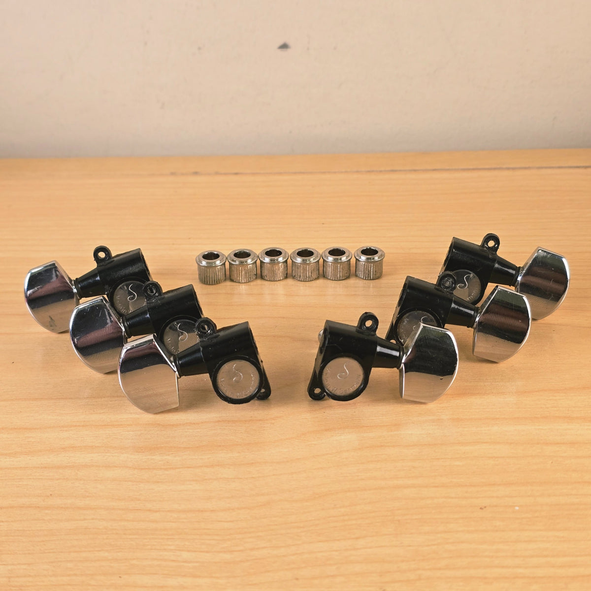Schaller 6-in-line guitar tuning machines set with bushings on wooden surface