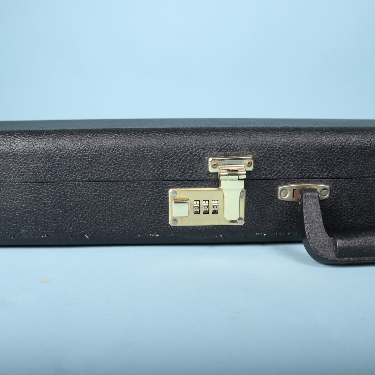 Tobias hardshell bass guitar case handle and central latch mechanism closeup